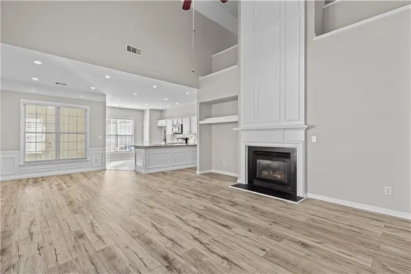 a view of an empty room with a fireplace and a window