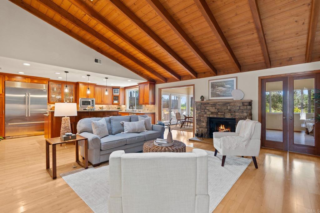 a living room with fireplace furniture and a wooden floor