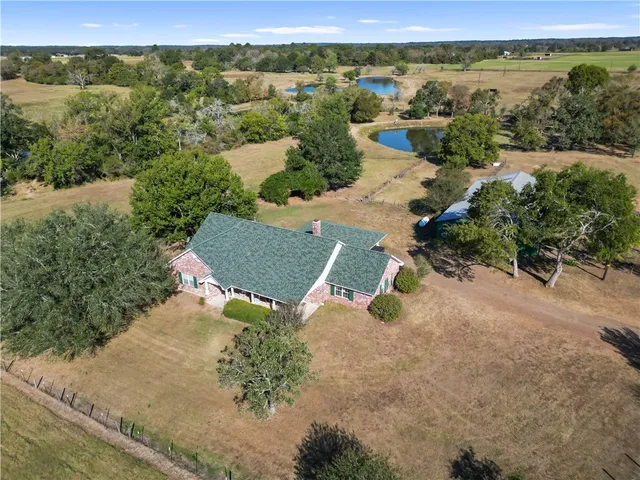 an aerial view of a house with yard