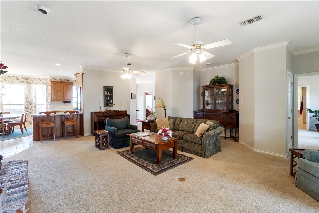 28109 Waller Gladish Road Waller, TX 77484 - Photo 22 of 28 a living room with furniture kitchen view and a chandelier