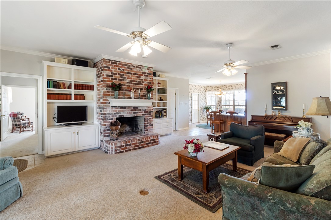 28109 Waller Gladish Road Waller, TX 77484 - Photo 23 of 28 a living room with furniture a fireplace and a flat screen tv