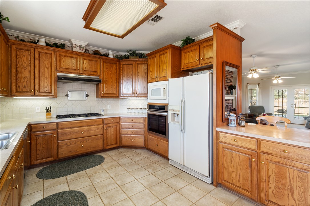 28109 Waller Gladish Road Waller, TX 77484 - Photo 27 of 28 a kitchen with stainless steel appliances a refrigerator sink and cabinets