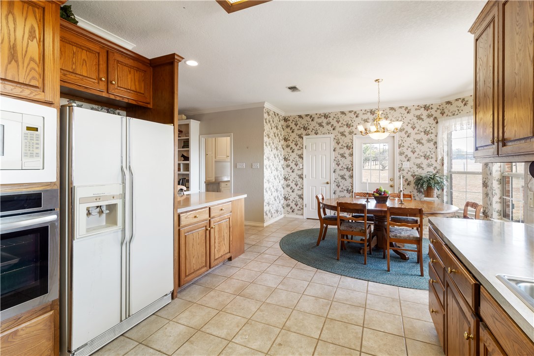 28109 Waller Gladish Road Waller, TX 77484 - Photo 28 of 28 a kitchen with stainless steel appliances granite countertop a refrigerator and a stove top oven