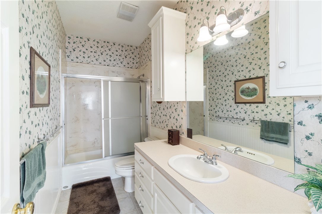 28109 Waller Gladish Road Waller, TX 77484 - Photo 7 of 28 a bathroom with a sink a toilet and shower