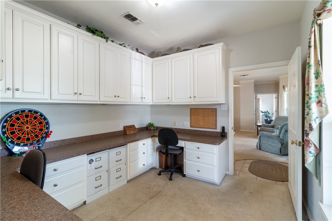 28109 Waller Gladish Road Waller, TX 77484 - Photo 8 of 28 a kitchen with white cabinets and a stove