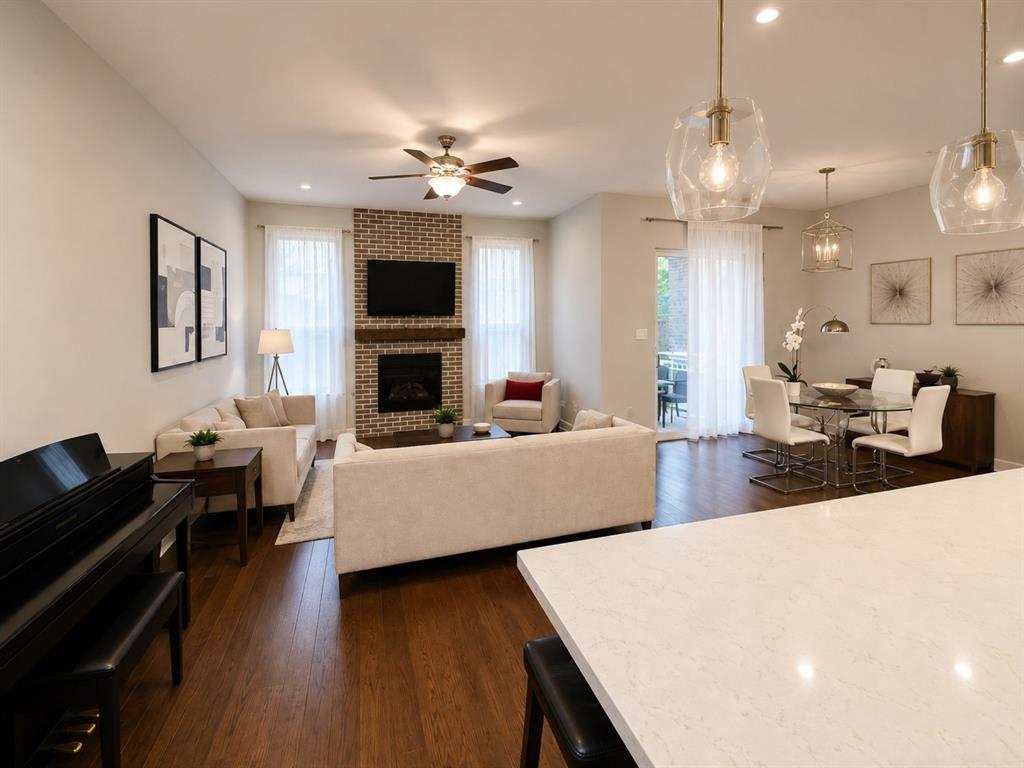 8235 Snapdragon Way Dallas, TX 75252 - Photo 5 of 29 Open-concept living space featuring wood-finish flooring and light-toned walls