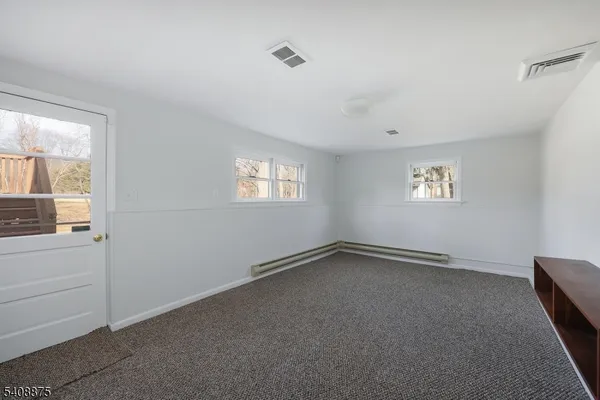 a view of an empty room and a window