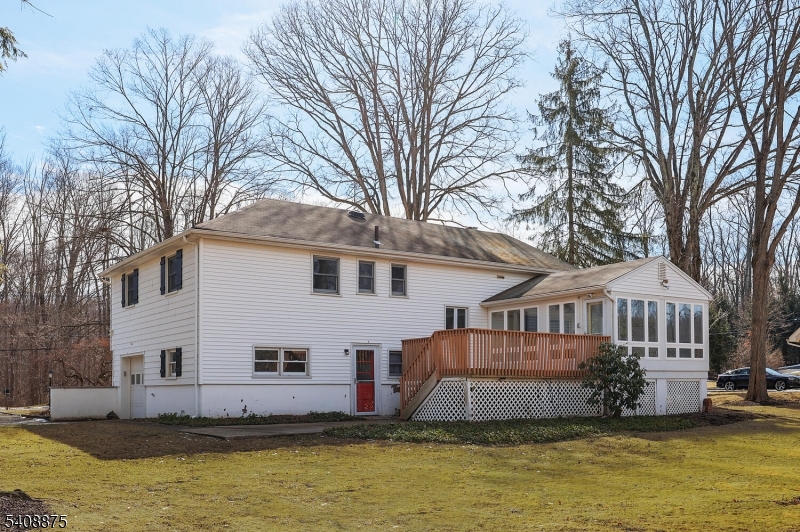 49 Overlook Road Morristown, NJ 07960 - Photo 22 of 28 a front view of a house with large windows and a large tree
