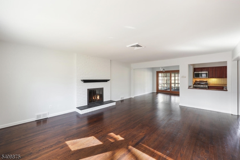 49 Overlook Road Morristown, NJ 07960 - Photo 5 of 28 a view of a livingroom with wooden floor fireplace and windows