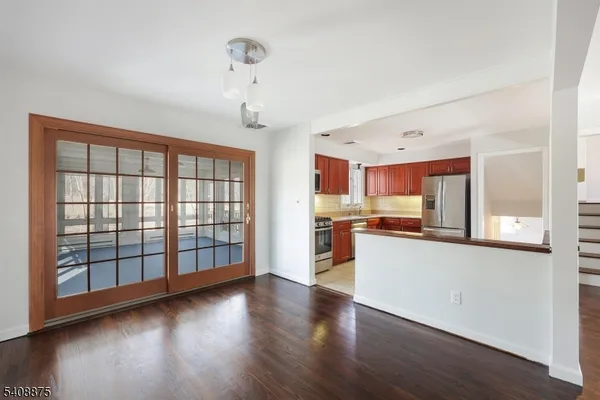 a large kitchen with hardwood floor and a view of kitchen