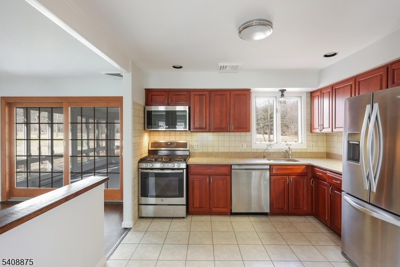 49 Overlook Road Morristown, NJ 07960 - Photo 10 of 28 a kitchen with stainless steel appliances granite countertop a stove sink and refrigerator