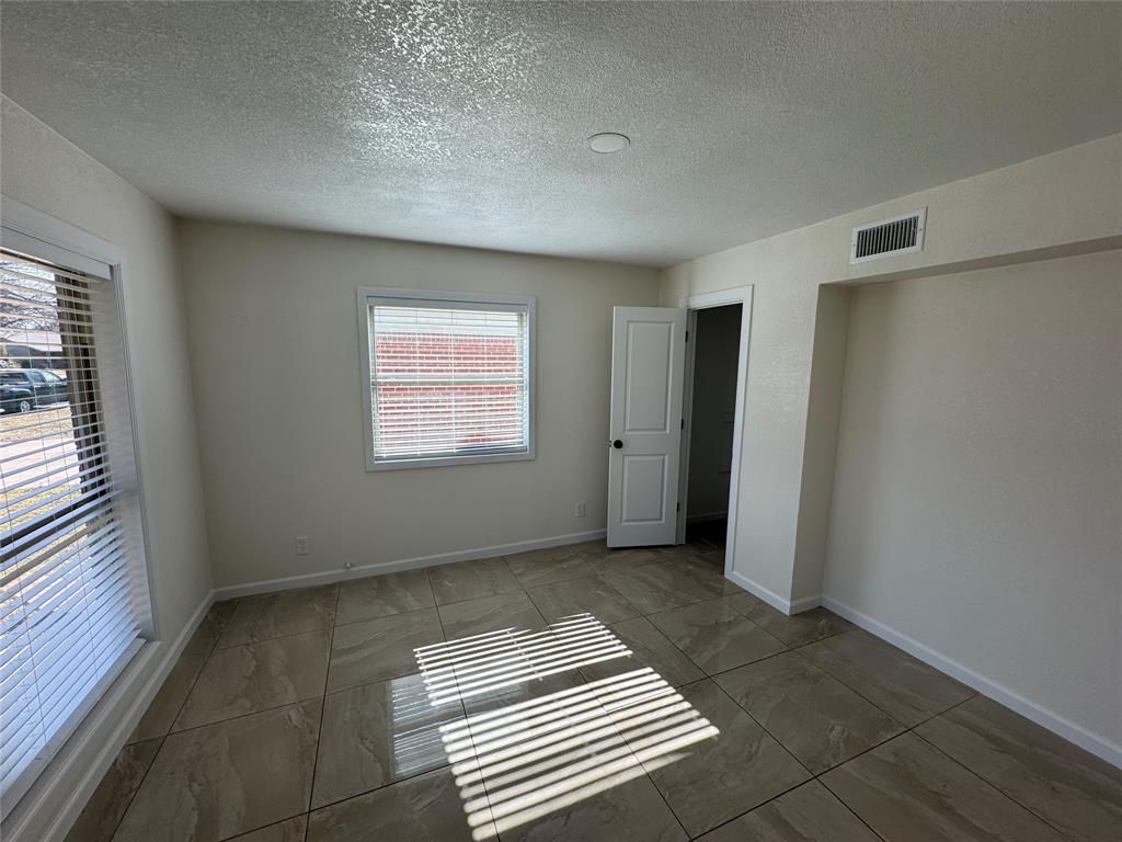 408 Steeple Ridge Road Everman, TX 76140 - Photo 3 of 14 a view of an empty room with a window