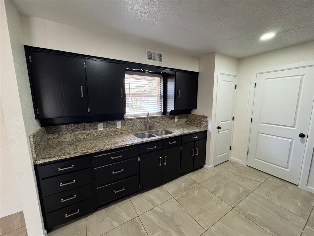 408 Steeple Ridge Road Everman, TX 76140 - Photo 6 of 14 a spacious bathroom with a granite countertop sink and a mirror