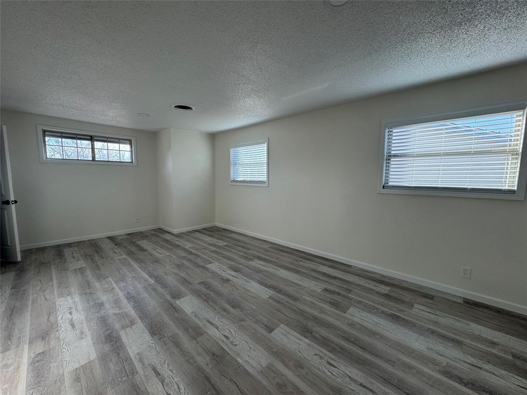 408 Steeple Ridge Road Everman, TX 76140 - Photo 8 of 14 a view of empty room with wooden floor