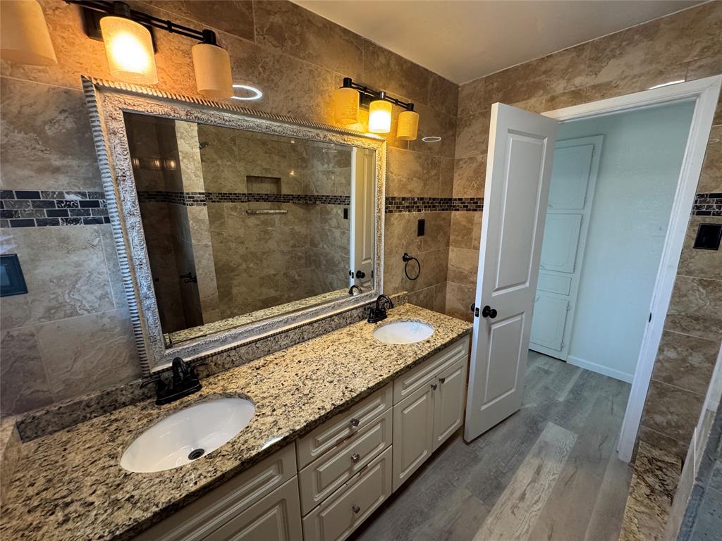 408 Steeple Ridge Road Everman, TX 76140 - Photo 9 of 14 a bathroom with a granite countertop sink and a mirror