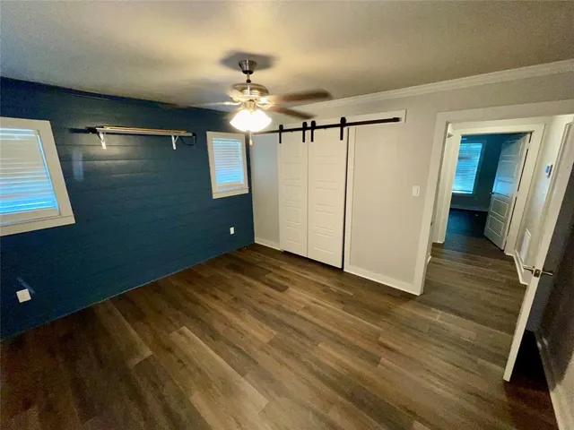 a view of empty room with wooden floor