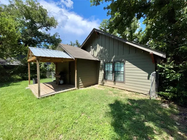 a view of a house with a yard patio and a garden