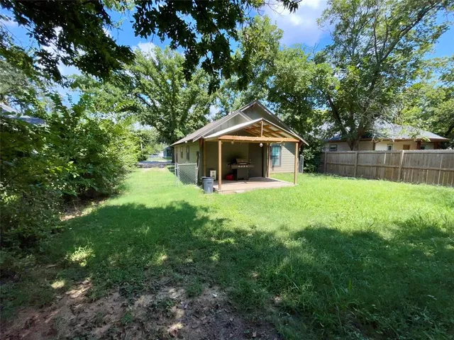 a front view of a house with yard and green space