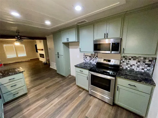 a kitchen with a stove and a microwave
