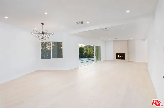 a view of a deck with a big yard and large trees