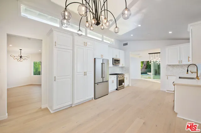 a view of a patio with a table and chairs
