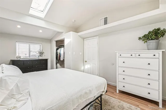 a bed room with a bed and a dresser