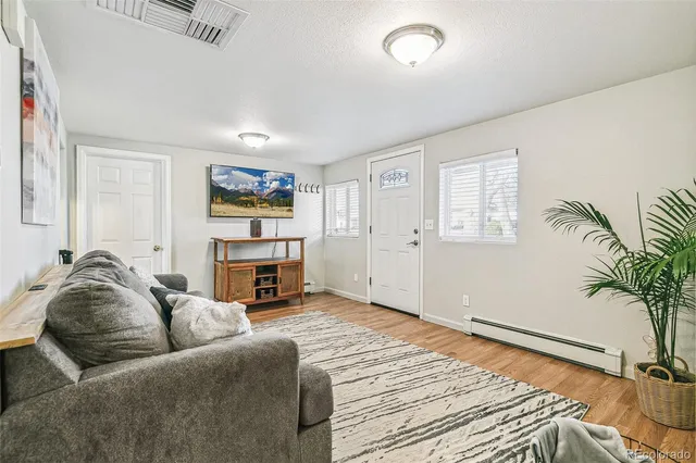 a living room with furniture and a fireplace
