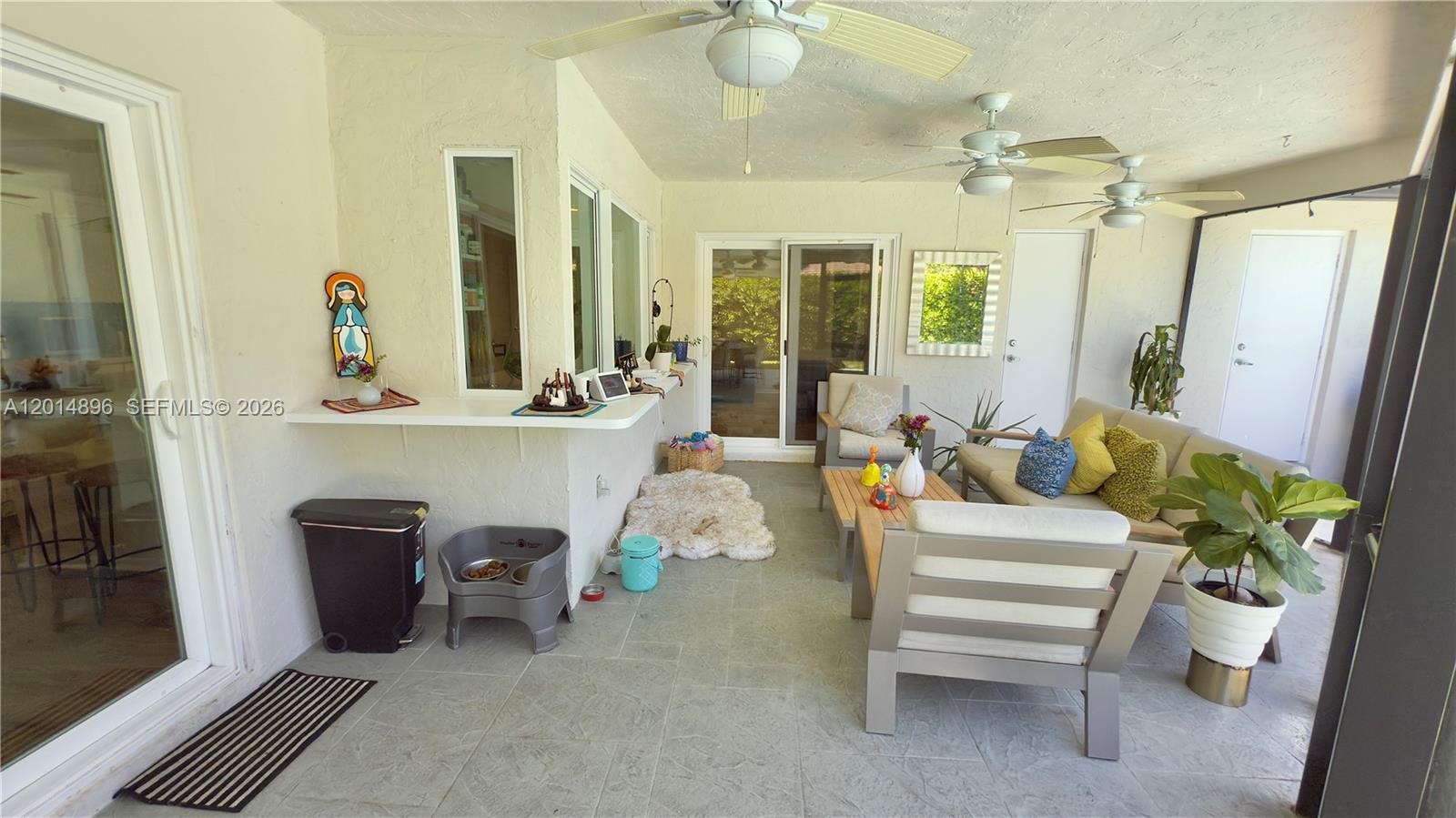 2411 Northwest 31st Street Boca Raton, FL 33431 - Photo 29 of 43 a living room with furniture and a chandelier