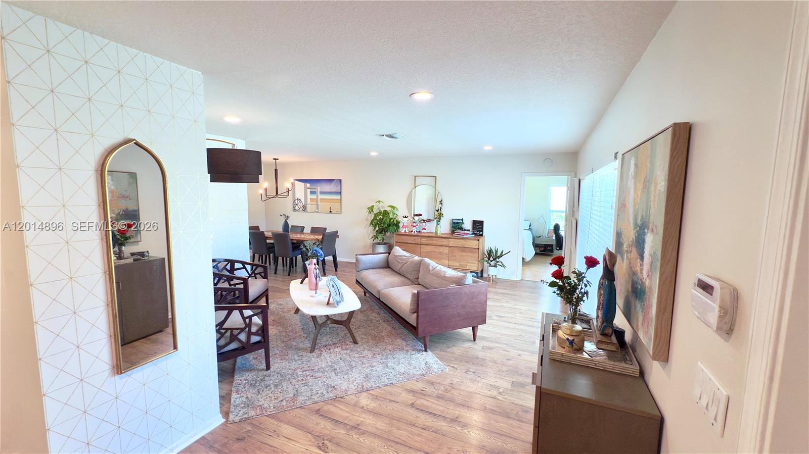 2411 Northwest 31st Street Boca Raton, FL 33431 - Photo 3 of 43 a living room with furniture and a flat screen tv