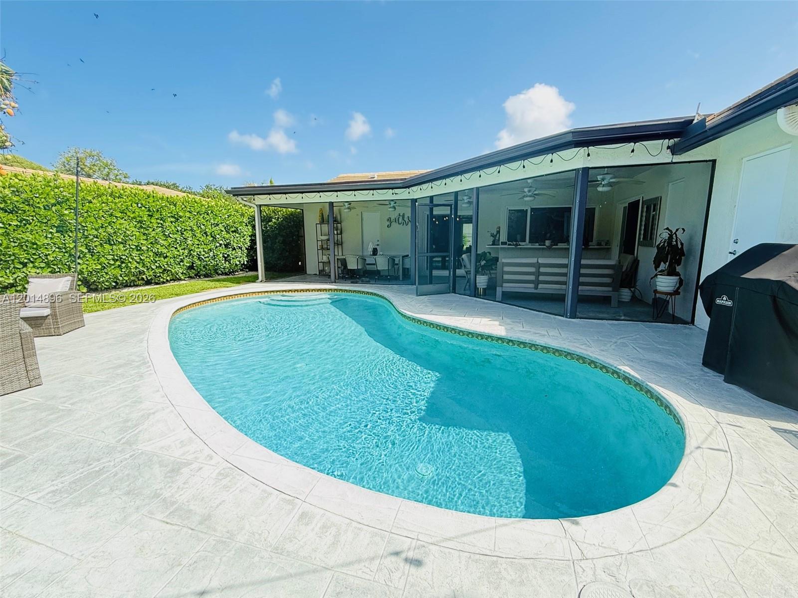 2411 Northwest 31st Street Boca Raton, FL 33431 - Photo 35 of 43 a view of a house with a backyard porch and sitting area
