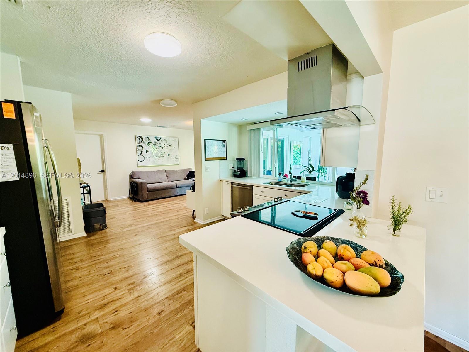2411 Northwest 31st Street Boca Raton, FL 33431 - Photo 6 of 43 a living room with furniture and a wooden floor