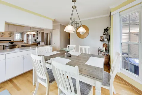 a view of a dining room and a dining table chairs in the kitchen