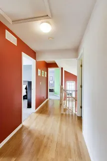 a view of a livingroom with furniture wooden floor and window