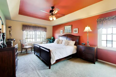 a bedroom with a bed and a chandelier