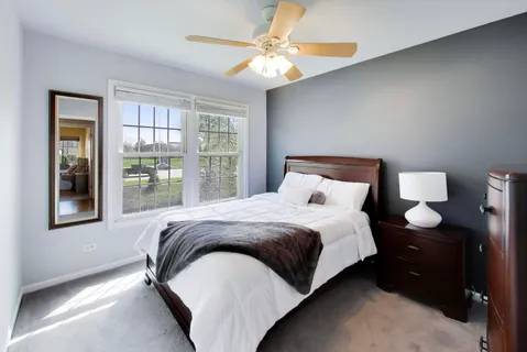 a large bed sitting in a bedroom next to a window