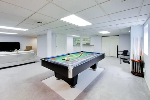 a room with furniture and pool table