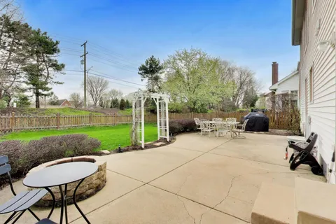 a view of a backyard with sitting area