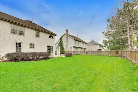 a view of a house with a yard and porch