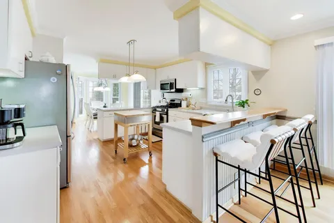 a kitchen with stainless steel appliances kitchen island granite countertop a sink and cabinets