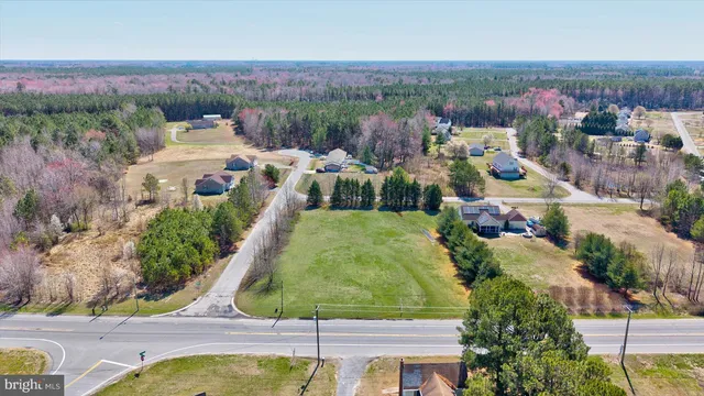 an aerial view of a house with a garden and lake view