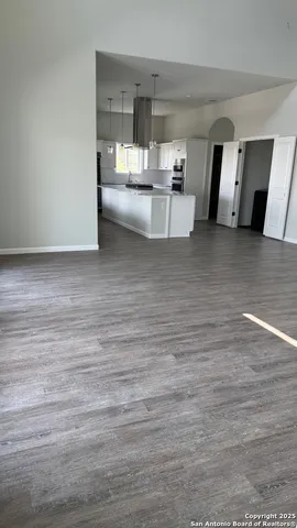 a white toilet sitting next to a white wall