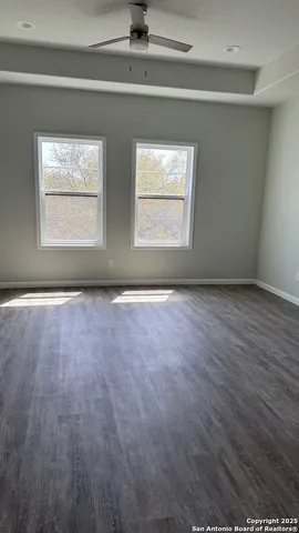 a view of backyard with swimming pool and green space