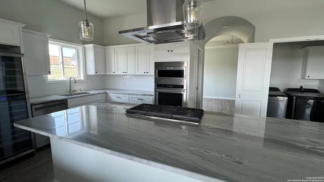 a kitchen with granite countertop a stove and a sink