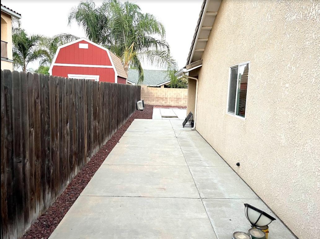 922 Sequoia Street Parlier, CA 93648 - Photo 12 of 16 a view of balcony with wooden floor and fence