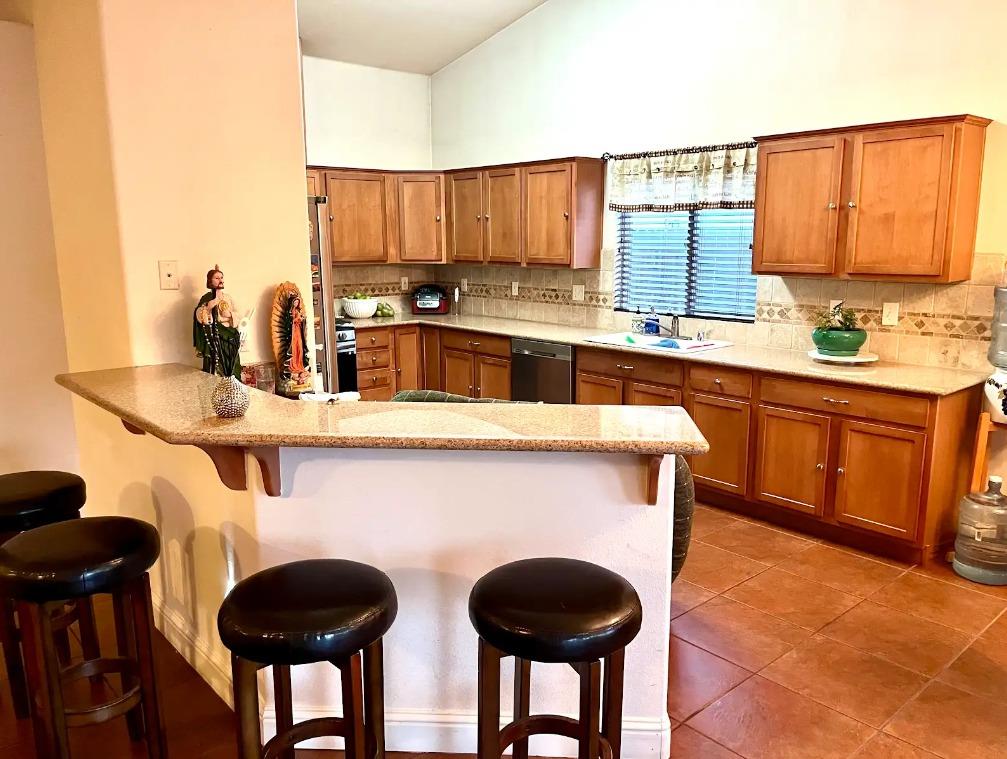 922 Sequoia Street Parlier, CA 93648 - Photo 3 of 16 a kitchen with stainless steel appliances a sink cabinets and a window
