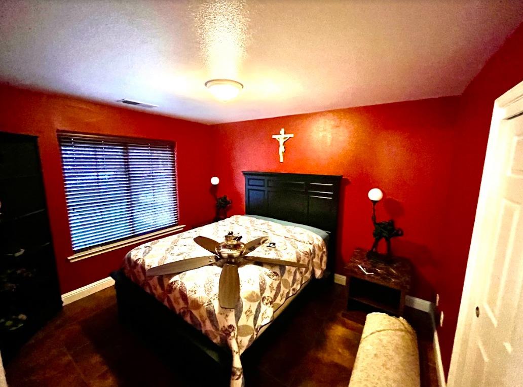 922 Sequoia Street Parlier, CA 93648 - Photo 6 of 16 a bed sitting in a room next to a lamp