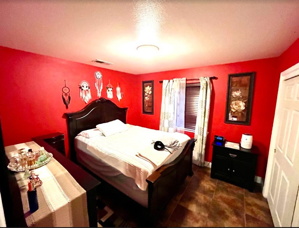 922 Sequoia Street Parlier, CA 93648 - Photo 8 of 16 a living room with furniture a flat screen tv and a bed