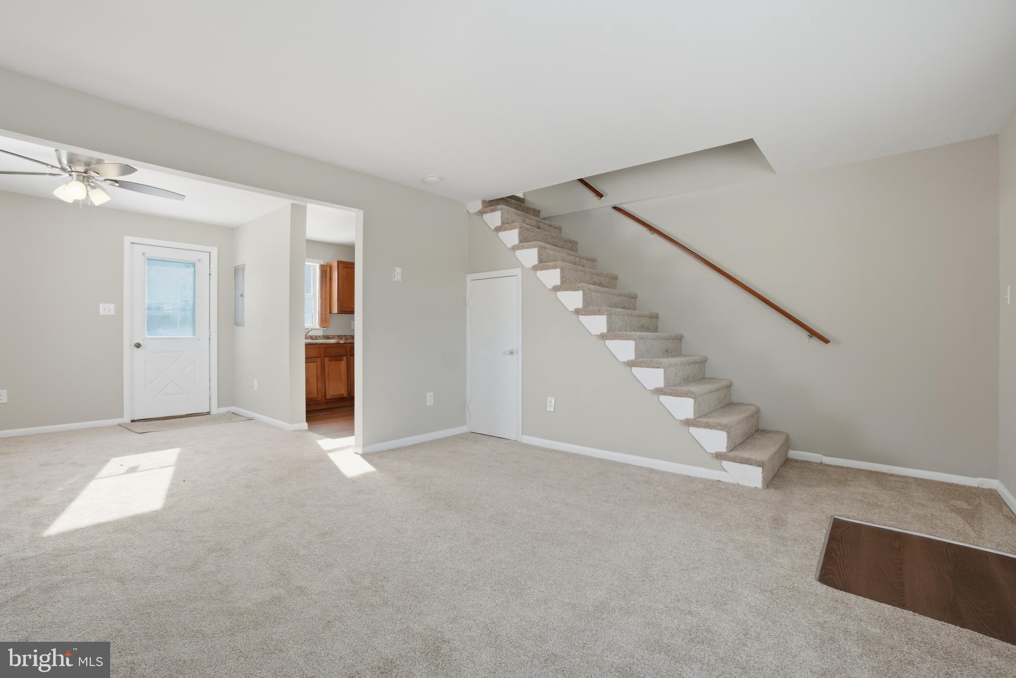 5605 Shelbourne Road, Unit B Baltimore, MD 21227 - Photo 3 of 20 a view of an empty room with stairs and a view of room
