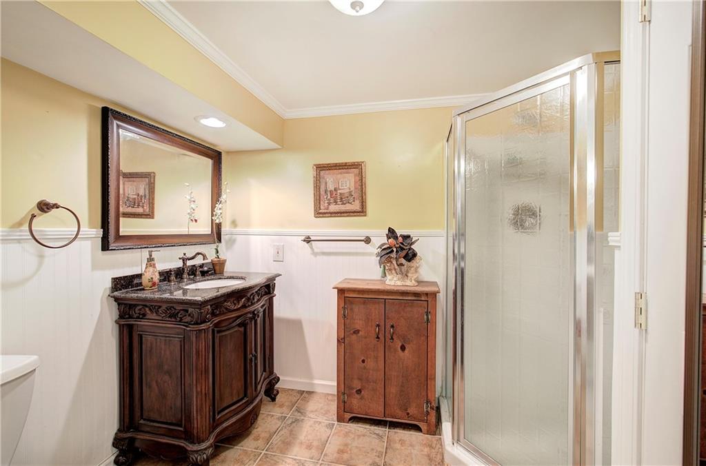 218 Gilreath Road Southeast Cartersville, GA 30121 - Photo 22 of 27 a bathroom with a sink a mirror and a shower