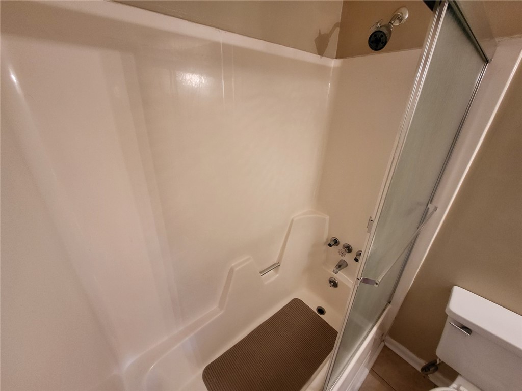 150 Ligon Street, Unit 1001 Clemson, SC 29631 - Photo 18 of 29 A well-maintained shower with a sliding glass door offers a functional bathing experience.